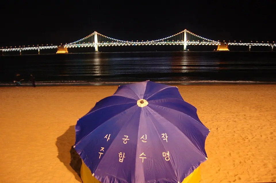 Beach umbrella and Gwangan Bridge at night